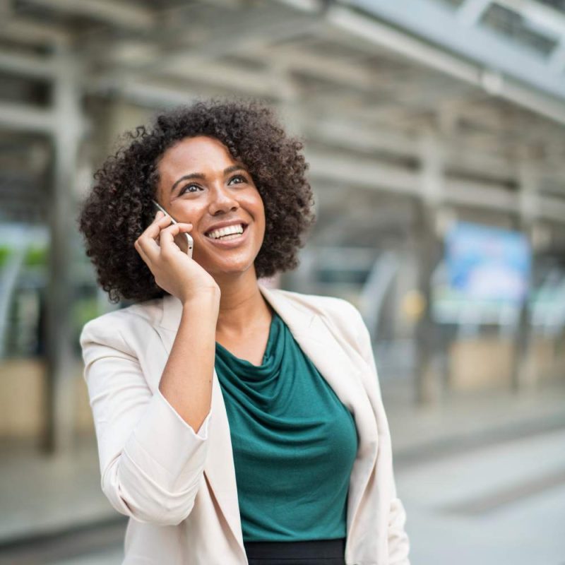 happy-businesswoman-talking-phone (1)